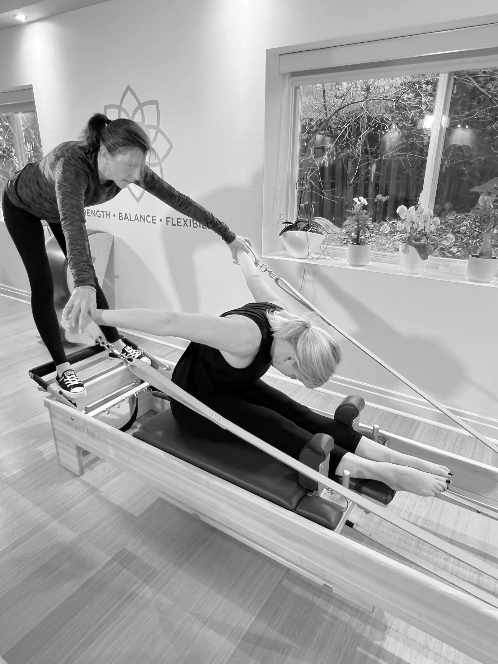 Kim guiding a client on the Reformer