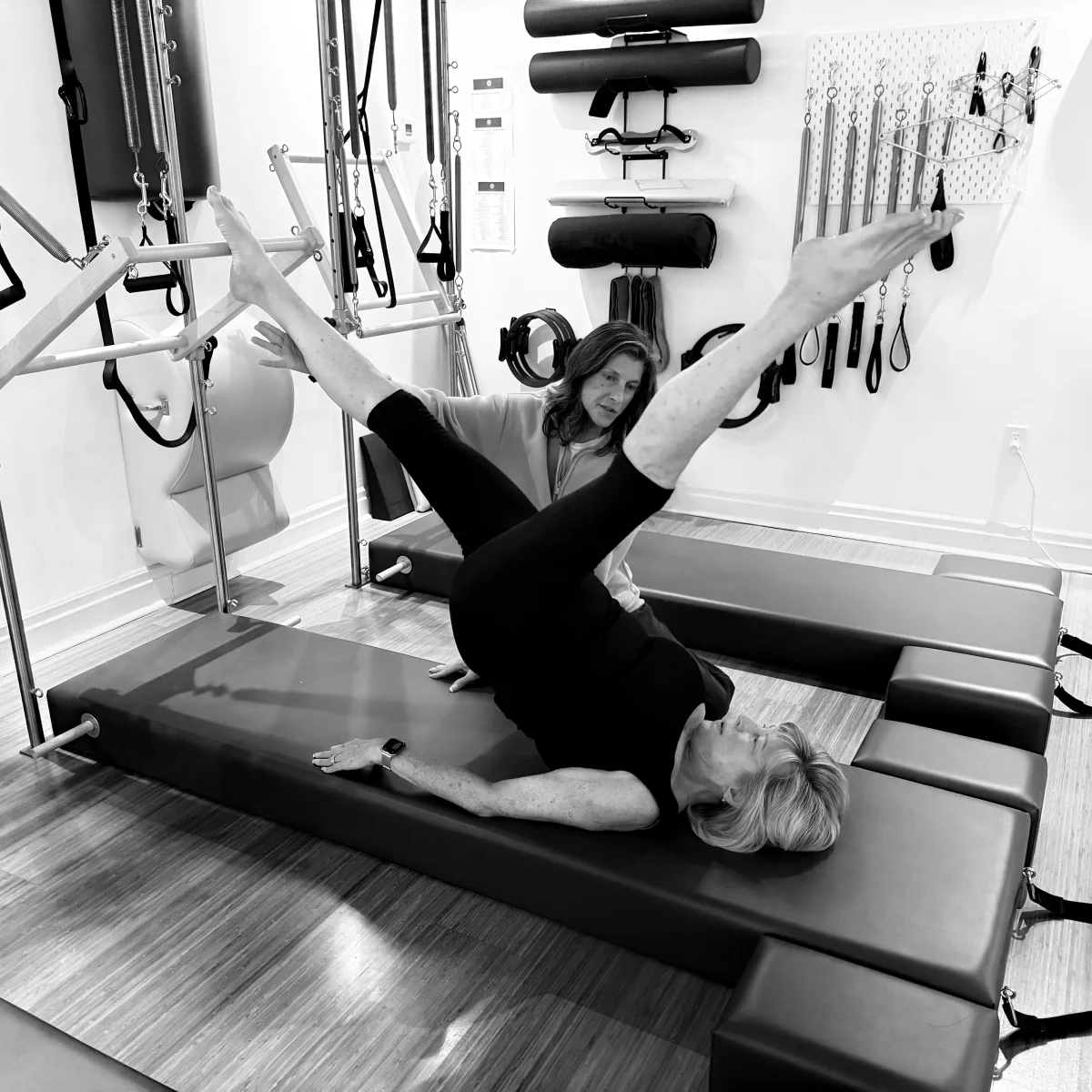 Christine practising Pilates with Kim guiding her at Heart of Movement
