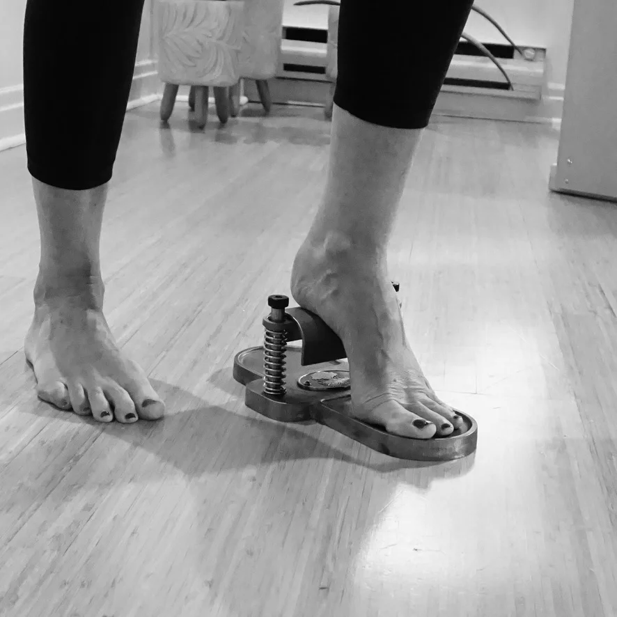 Close-up of a foot using a Pilates foot corrector
