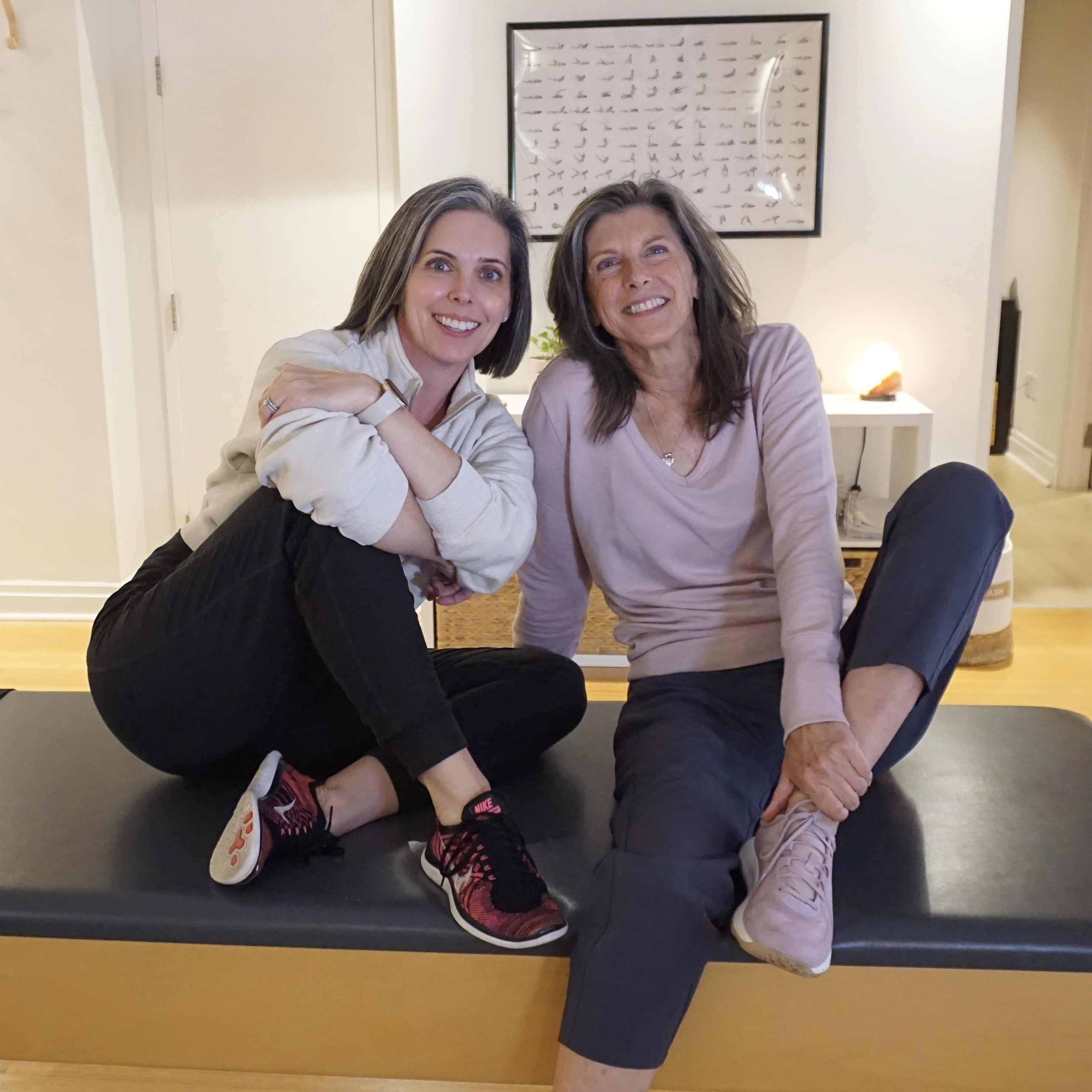 Joanne Decorte and Kim Radovich seated together at Heart of Movement Pilates studio in Oakville