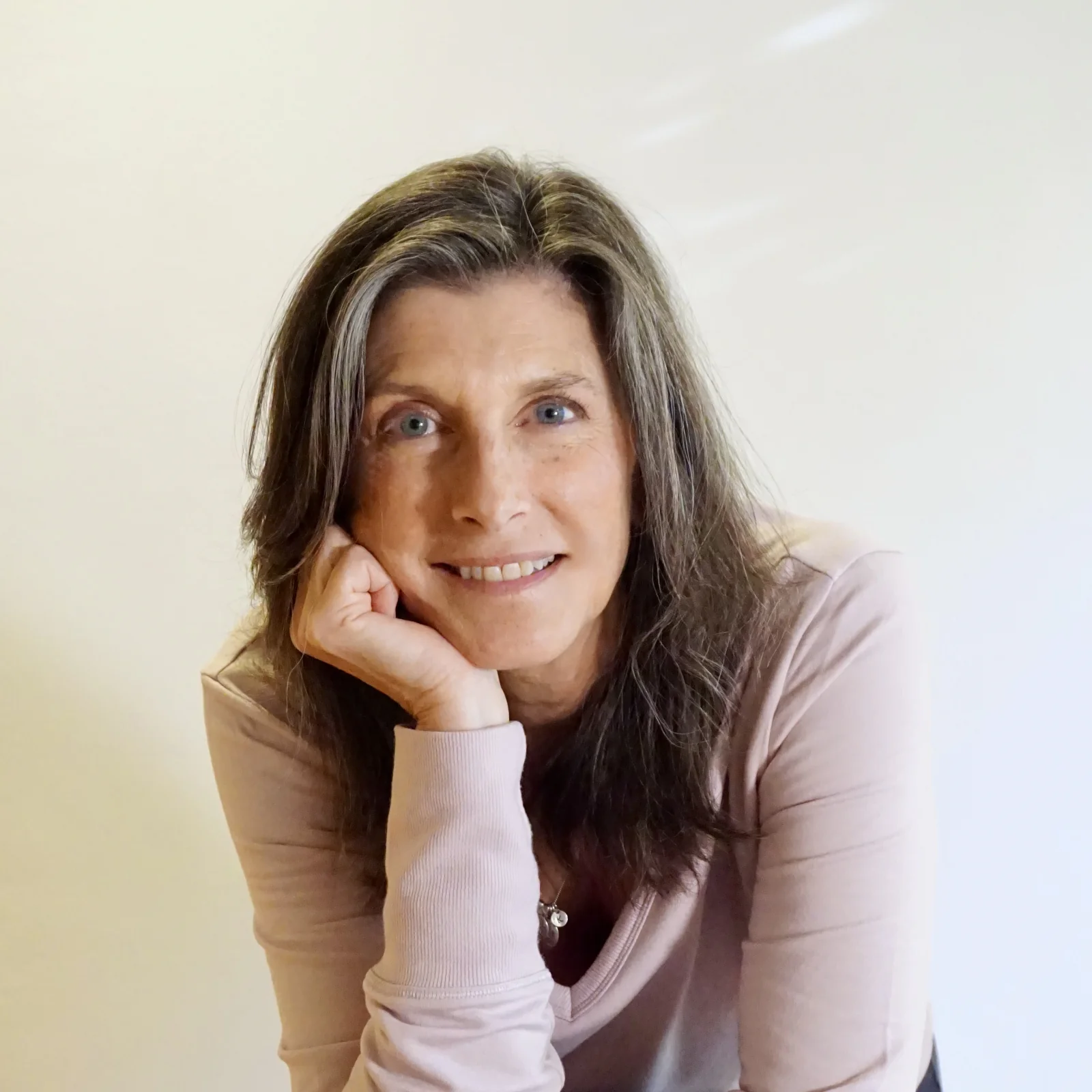 Kim Radovich, founder and Classical Pilates teacher, wearing pink
