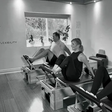 Three clients practising together on Reformers at Heart of Movement